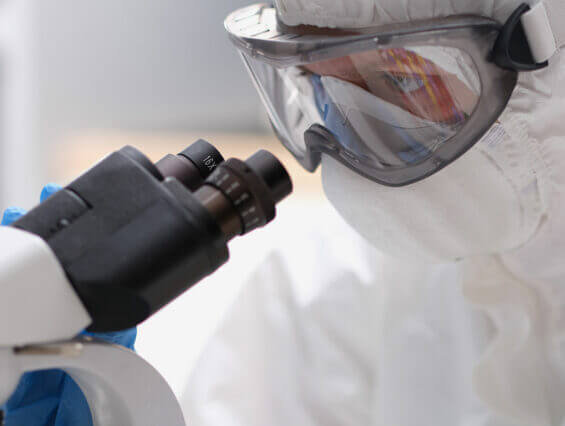 CDMO manufacturing researcher looking with a microscope